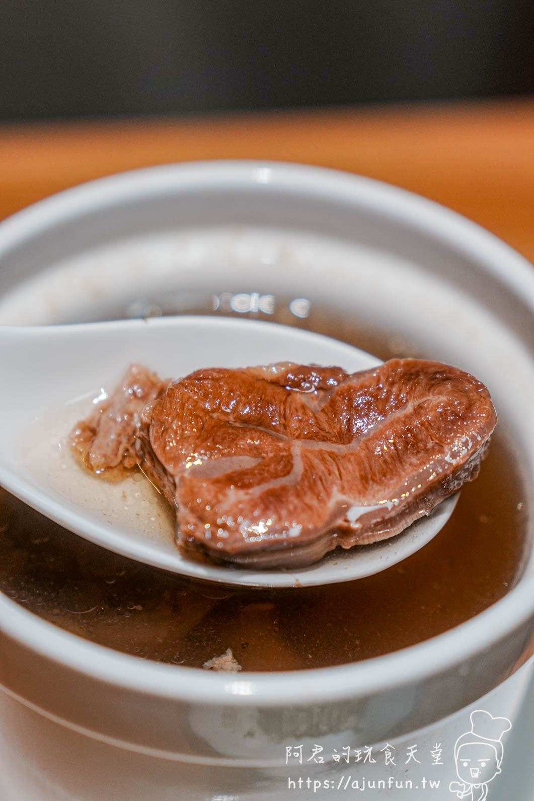 滬舍餘味西屯店清燉牛腱心湯-湯匙撈起一塊軟嫩牛腱心肉湯色金黃透亮
