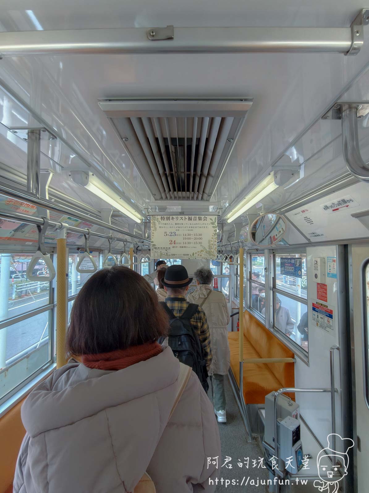 谷地頭溫泉 路面電車車廂內乘客站立與藍色集會告示 - 阿君的玩食天堂