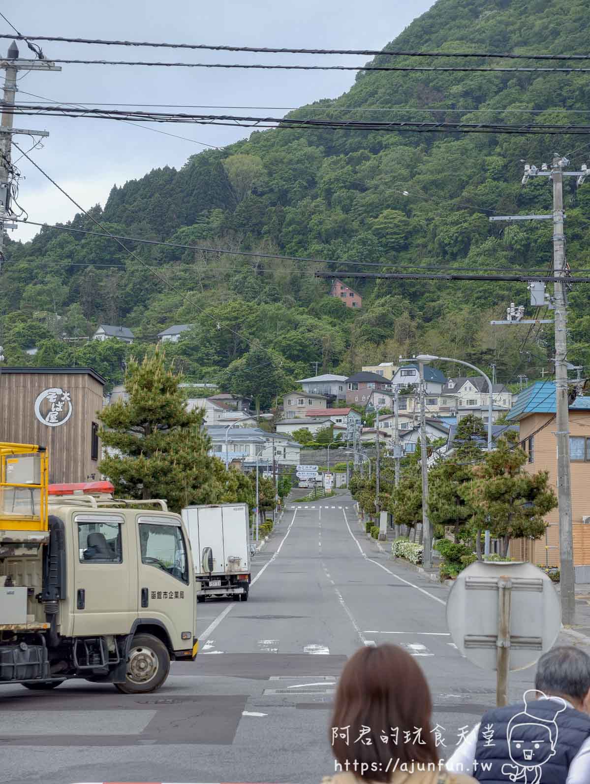 谷地頭溫泉 通往綠色山腳的筆直住宅街道與函館市企業局貨車 - 阿君的玩食天堂