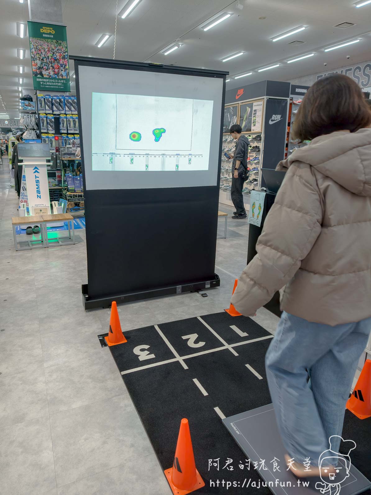 【函館購物】SPORTS DEPO 函館梁川店足底量測、價格與免稅實測 - 第6張圖 SPORTS DEPO函館 足底壓力量測區——投影幕顯示熱感圖與感測踏墊 - 阿君的玩食天堂